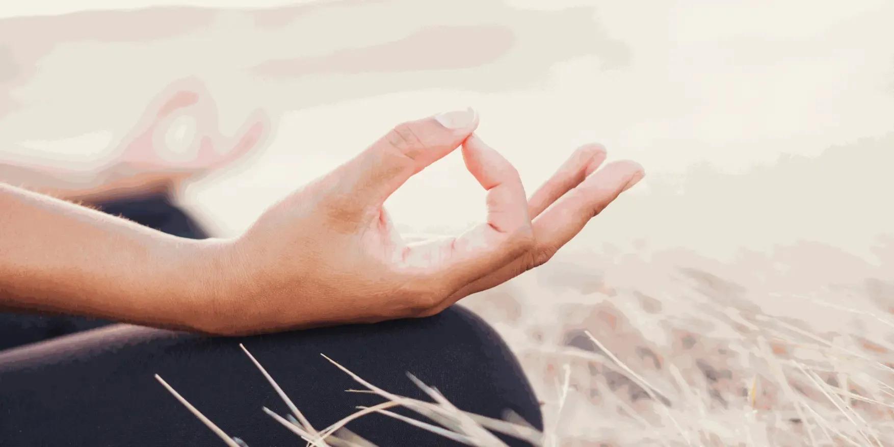 Hand resting on a knee in a meditation posture